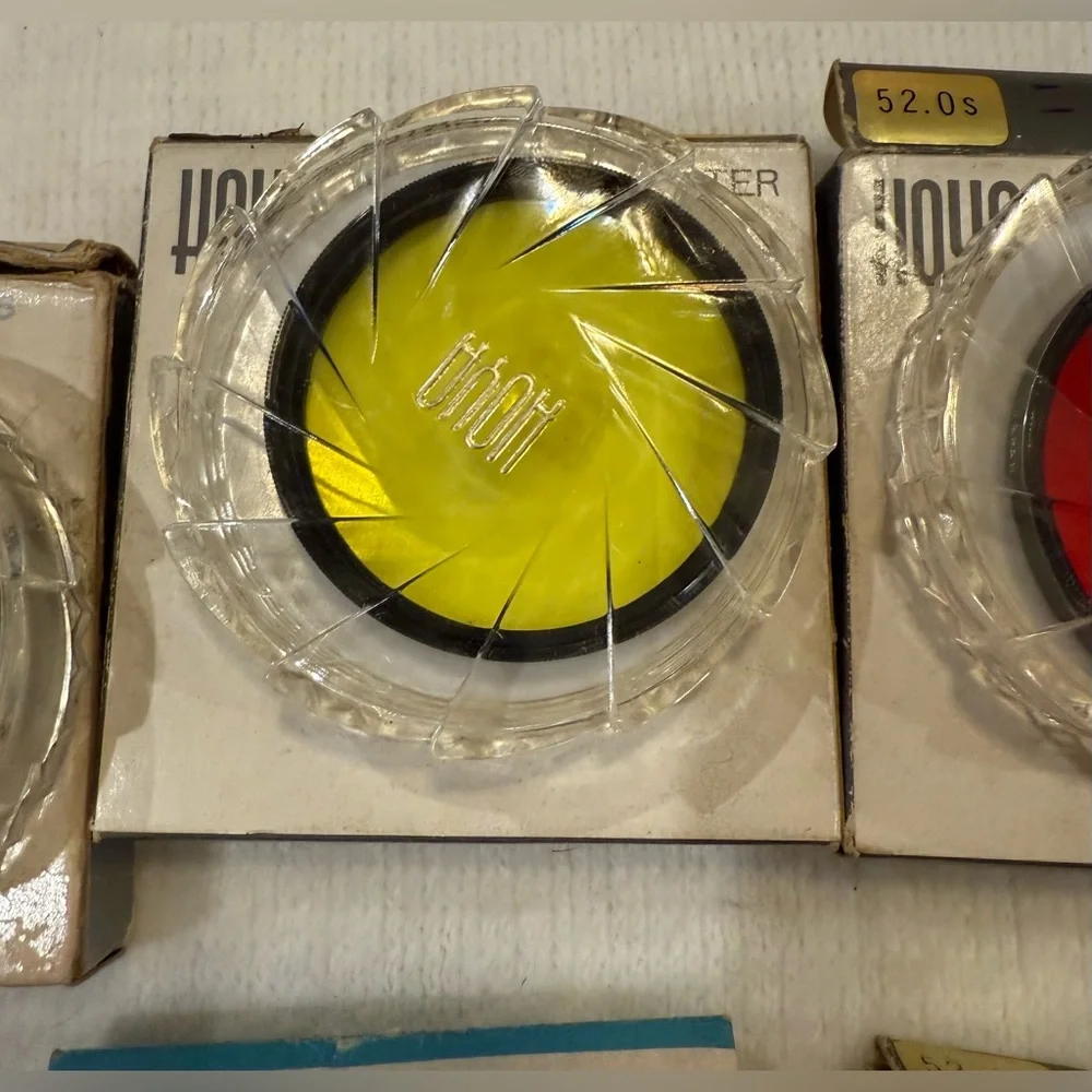 Lot of 4 Hoya photographic filters and 4 filter cases.